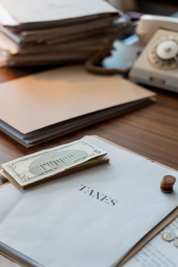 Financial paperwork and cash on a desk